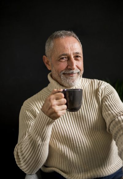 smiling-elderly-male-with-hot-drink